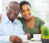 caregiver and a senior man smiling