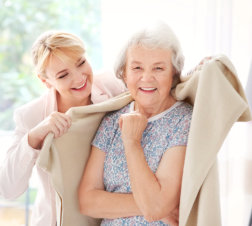 caregiver placing blanket to a senior woman