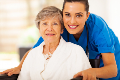 caregiver and a senior woman smiling